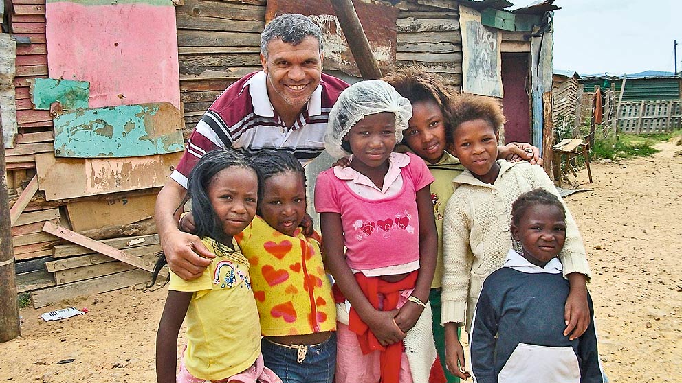 Wilfred Fritz with some children whose homes he and his students connected to mains electricity