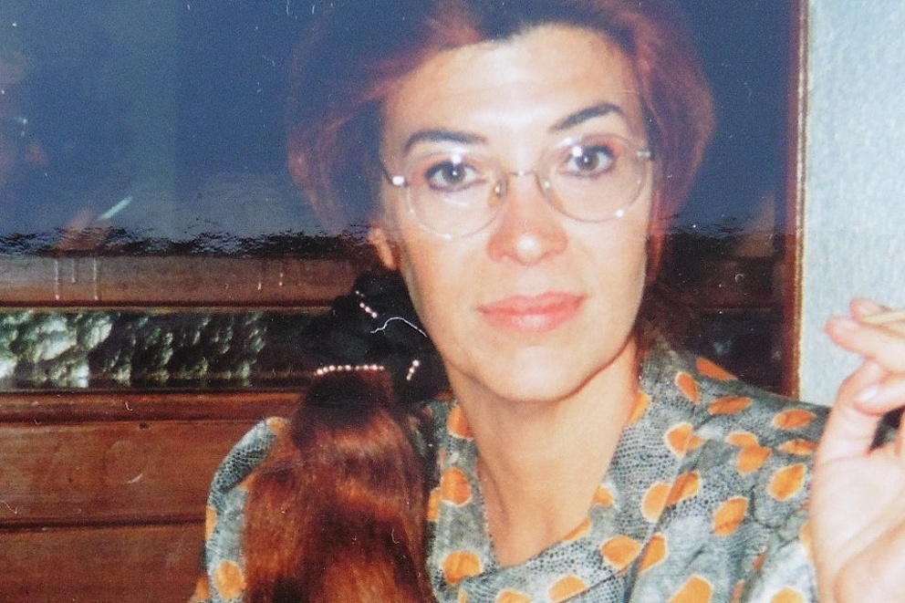 Eine Frau mit Brille in geblümter Satinbluse