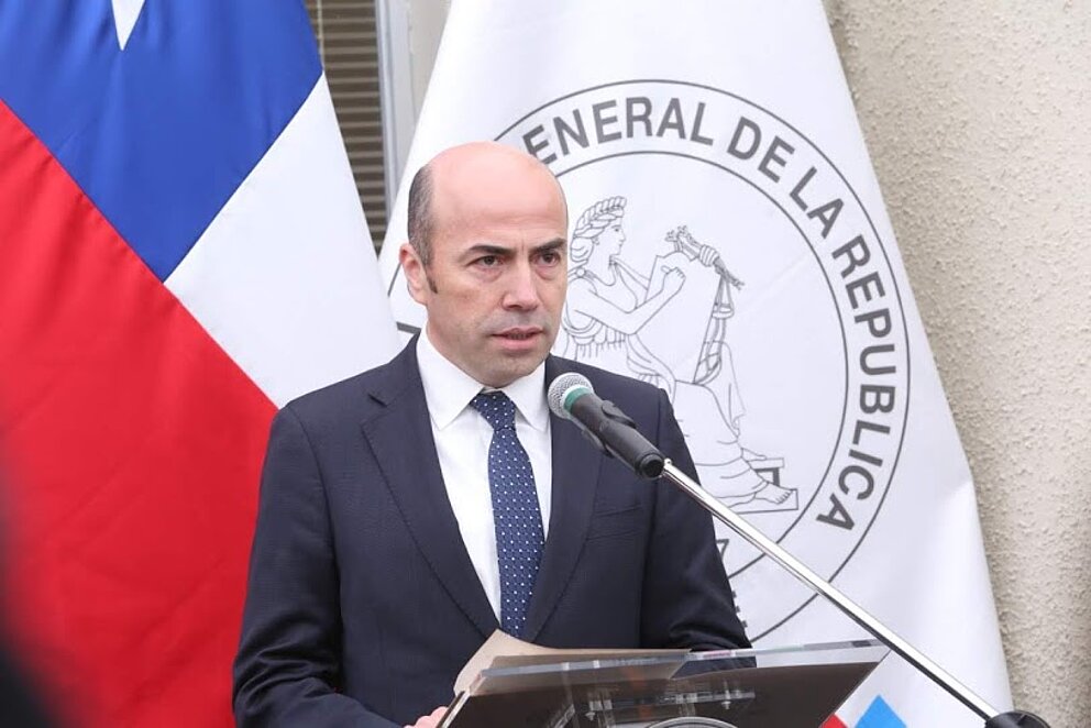 Generalkontrolleur der Republik Chile Jorge Bermúdez Soto bei einer Rede. Er steht vor einer chilenischen Fahne.