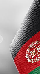 Small national flags of the Afghanistan on a light blurry background